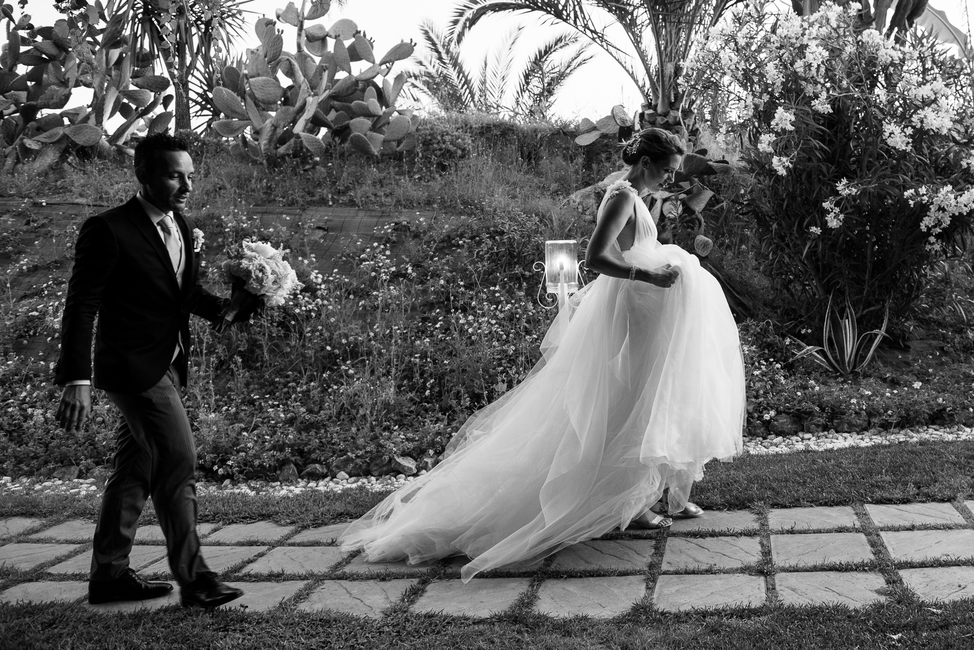 Destination wedding in Southern Italy — bride and groom walking through a Calabria garden venue